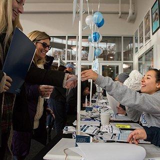 student welcoming visitors during Open House